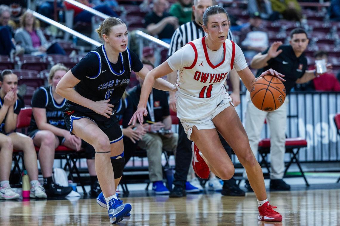 Owyhee senior Mikale Roy drives past Coeur d’Alene’s Karisa Wallis in the semifinals of the 6A girls basketball state tournament.
