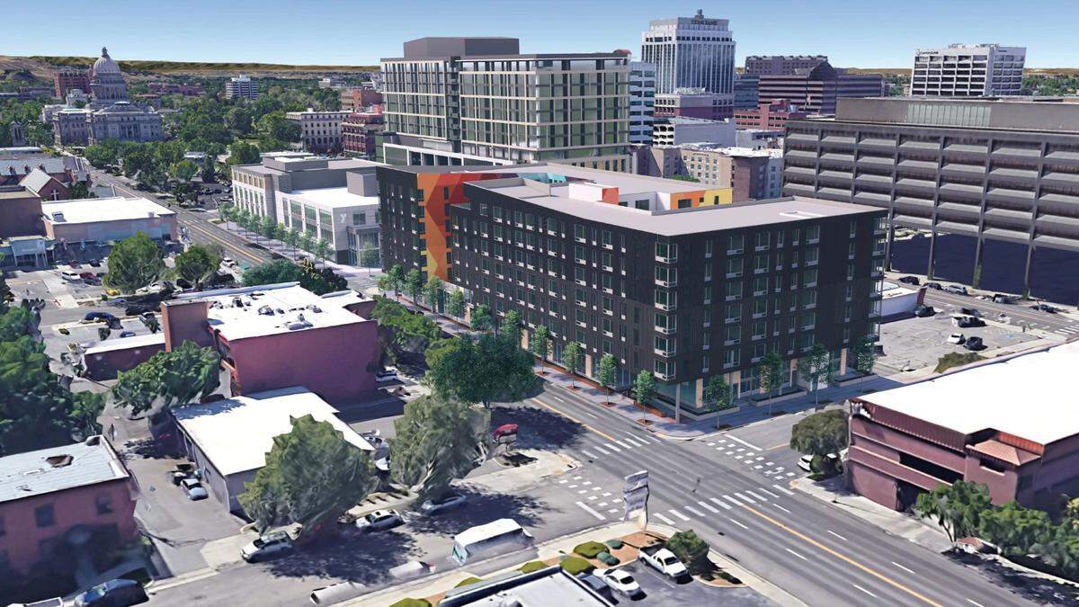 This rendering shows a proposed seven-story apartment building with ground floor commercial space, in center. The proposed new downtown YMCA is at left while a 15-story building can be seen just behind. The Idaho State Capitol is at far upper left.