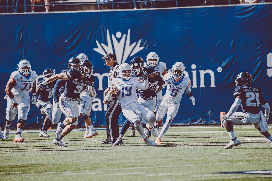 Boise State quarterback Hank Bachmeier slides down after running for a fist down Saturday at Utah State.