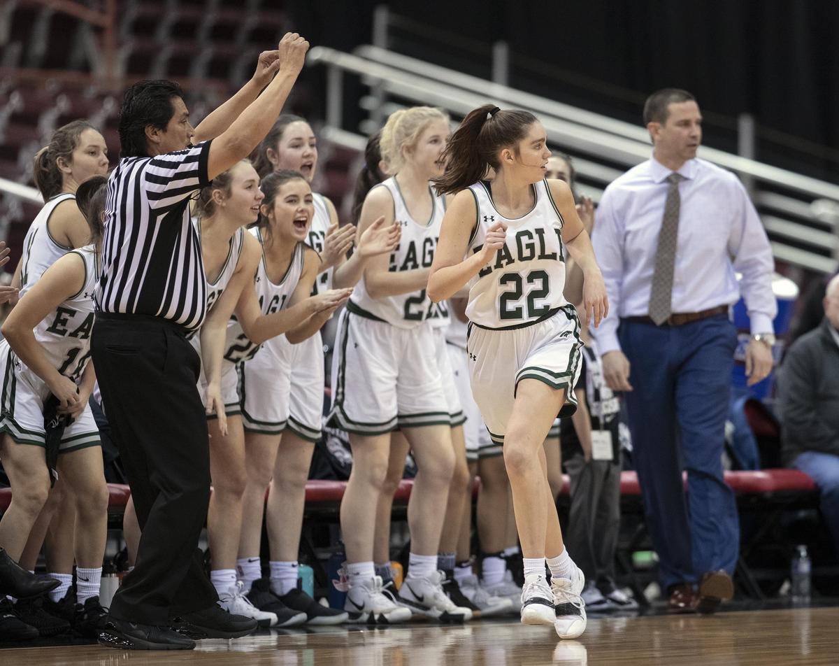 Eagle’s bench cheers Betsey King after she hit a 3-pointer in the 5A state tournament last year.