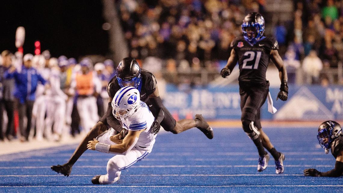 Boise State safety JL Skinner tackles BYU quarterback Jaren Hall as fellow defensive back Tyreque Jones looks on during the Broncos’ loss to the Cougars last November. Both Skinner and Jones were invited to the NFL Scouting Combine.