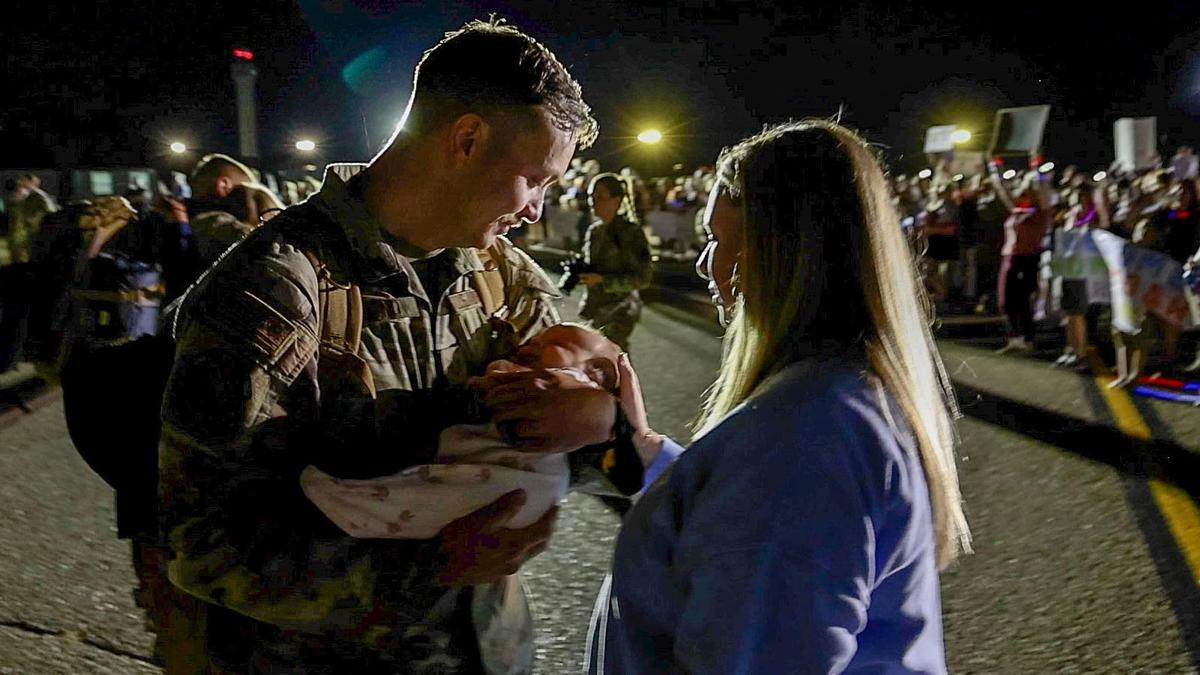 Technical Sgt. Blake Daquino sees his newborn child for the first time.