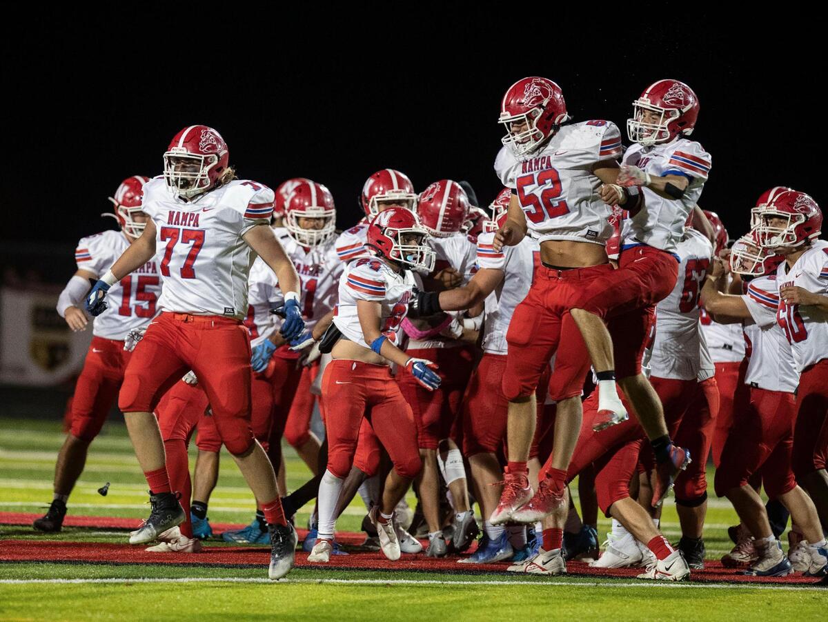 Nampa’s football team celebrates a 26-24 win at Owyhee last fall. The Bulldogs’ petition to drop a level in football was rejected Tuesday. But Nampa’s soccer, volleyball, basketball, baseball and softball programs will all drop to the new 5A starting next fall.