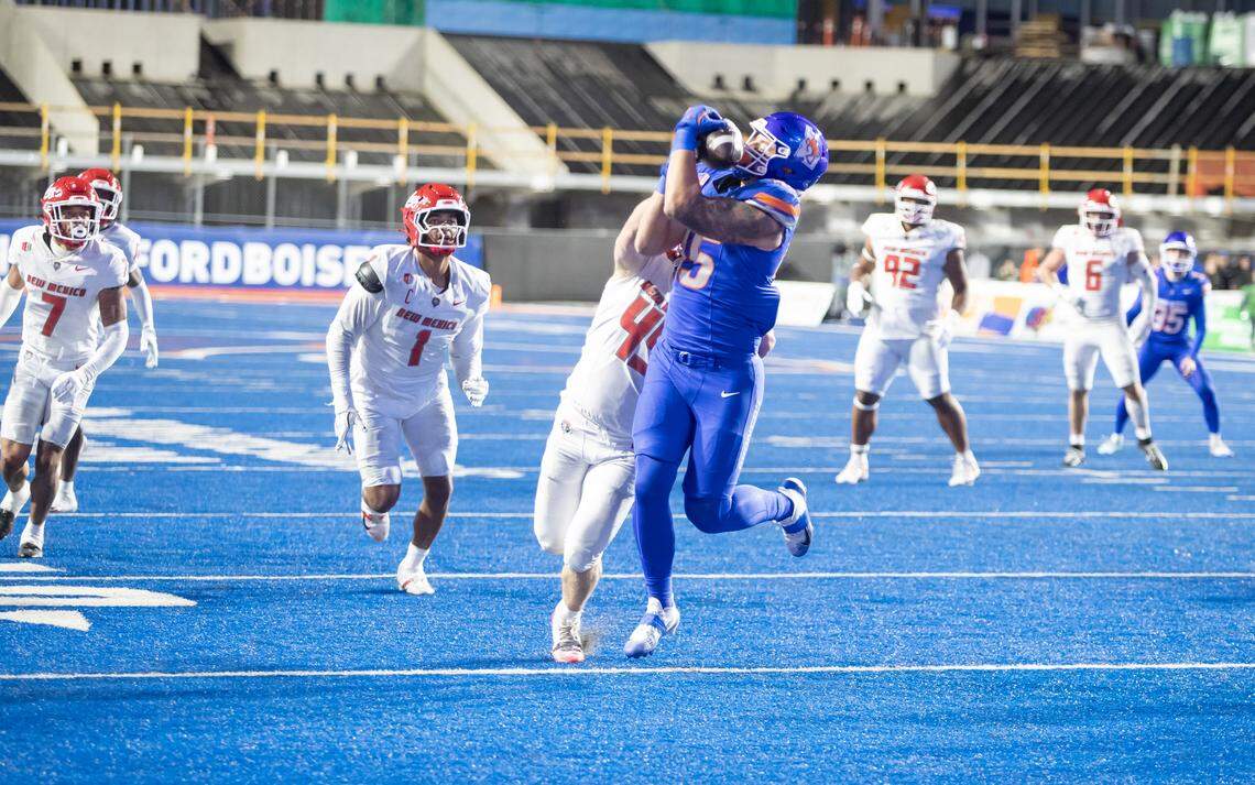Boise State tight end Troy Grizzle catches a 10-yard touchdown pass from Oscar Doyle over New Mexico defensive end Brett Karhu during the game at Albertsons Stadium two weeks ago.