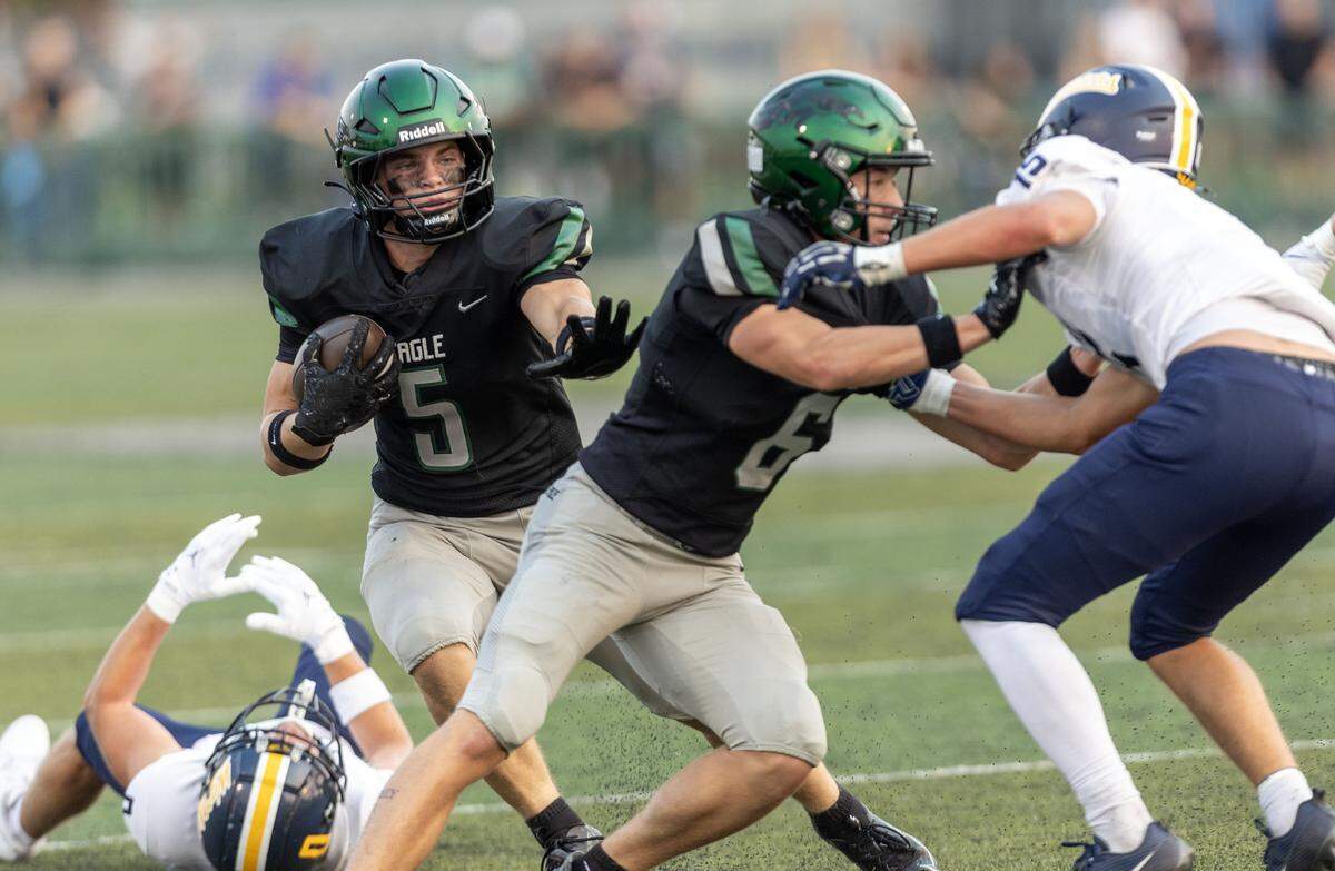 Eagle running back Luke Mikita follows a block from receiver Cooper Murphy for a first down gain against Meridian in 6A SIC football action at Eagle, Friday, Aug. 29, 2025.