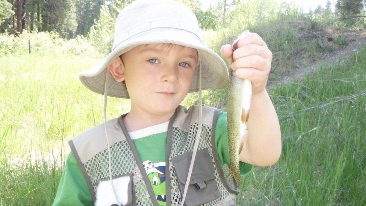 Aidan Nichols Long holds the first fish he ever caught. A scholarship that helps kids with disabilities spend time outdoors has been established by the Backcountry Hunters and Anglers.