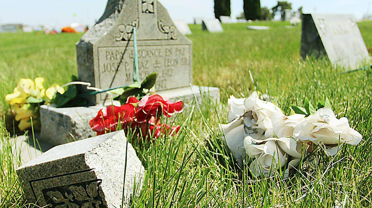 A grave marker sits damaged in the Hilltop Memorial Cemetery near Nyssa Thursday. Vandals struck the cemetery last Wednesday night and police are investigating.