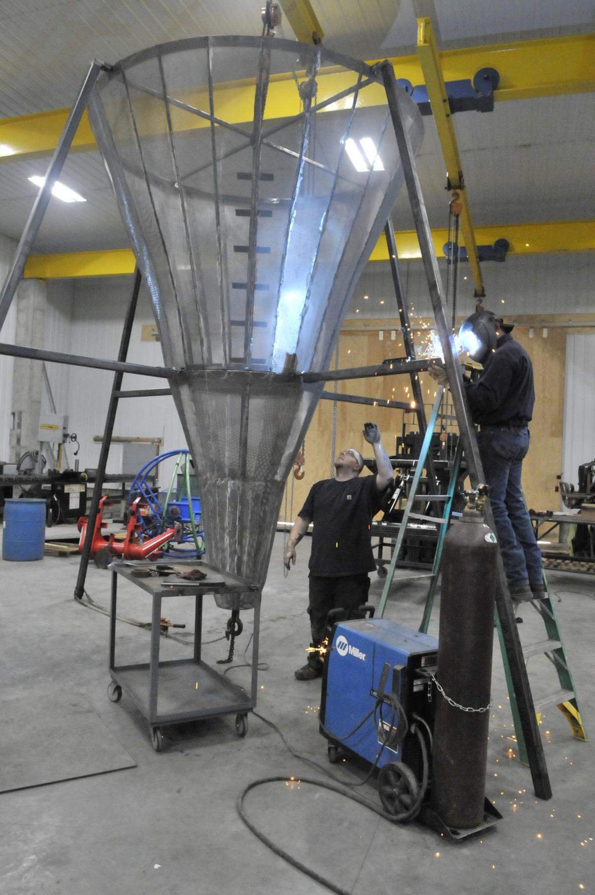 On Friday, a work crew at Christensen Machine Shop welds the stand for a giant ‘’sugar beet’ to be dropped by a crane on the Rupert Square on New Year’s Eve.