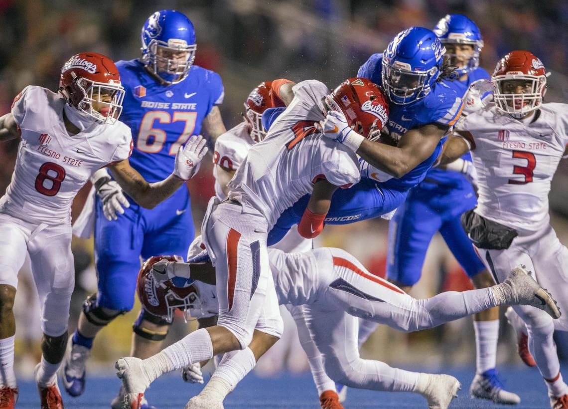 Boise State running back Alexander Mattison (22) leaps to avoid Fresno State defensive back Anthoula Kelly (6) but hits Fresno State defensive back Mike Bell (4) midair in the second quarter of the Broncos’ 24-17 victory Friday, Nov. 9, 2018 at Albertsons Stadium in Boise.