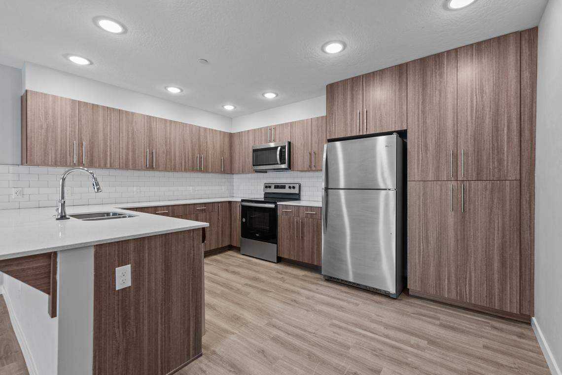 The apartments include five floor plans with a mix of one-, two- and three-bedroom units ranging in size from 580 square feet to 1,202 square feet. This image shows the kitchen area of one of the units.