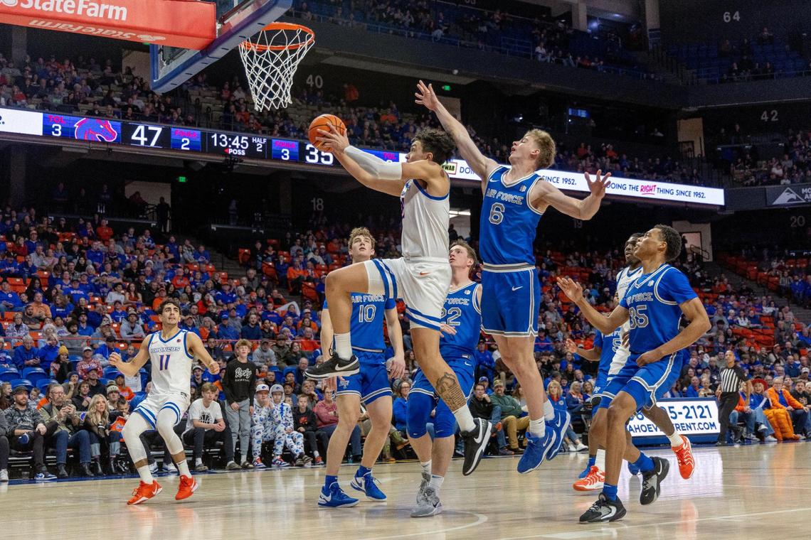 Boise State’s Javan Buchanan makes a basket as Air Force’s Will Cooper defends in the second half of their basketball game at ExtraMile Arena, Saturday, Dec. 21, 2024.