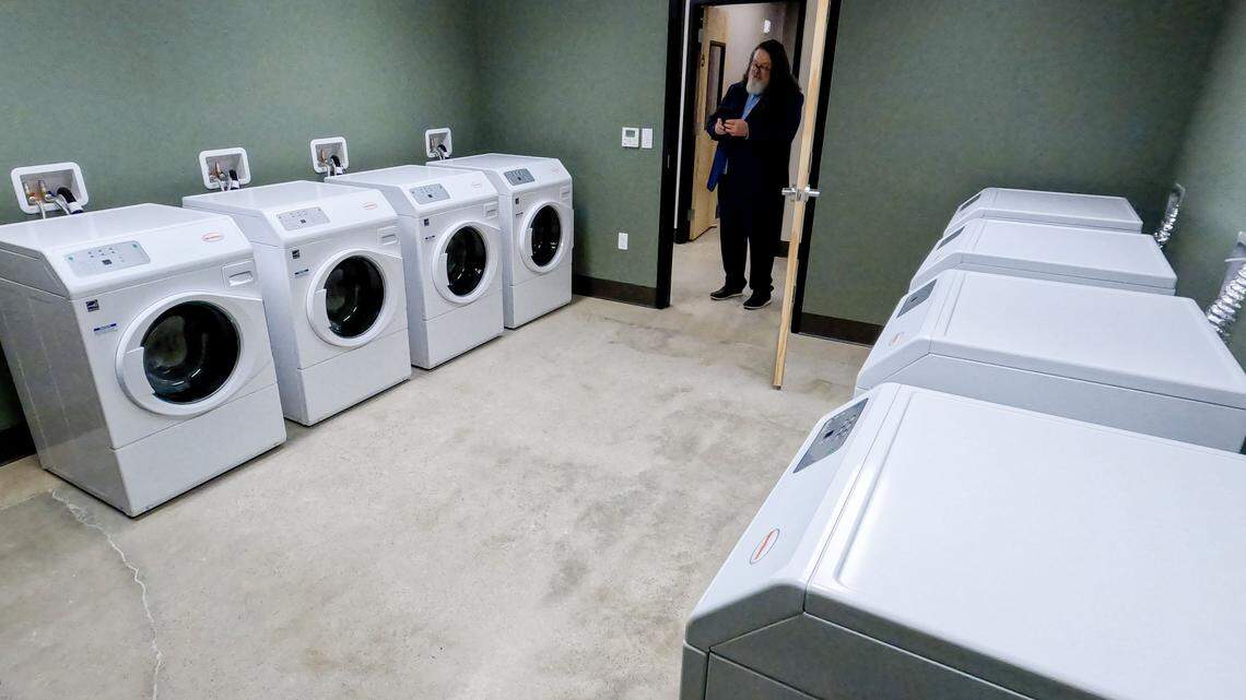 During a tour of Interfaith Sanctuary's new location on State Street in Boise, Geoffrey Wardle, an attorney who represents the organization, takes a photo of the new laundry room facilities.