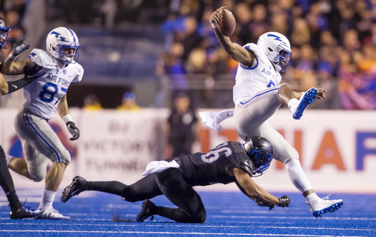 Boise State cornerback Avery Williams (26) tackles Air Force quarterback Donald Hammond III (5) Friday, Sept. 20, 2019 at Albertsons Stadium in Boise.