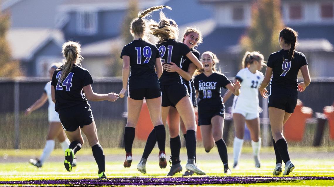 Rocky Mountain rushes to teammate Violet Rademacher after she scores a goal from long distance during the 2019 state tournament.