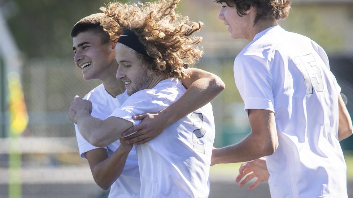 Jon Isasi , left, hugs teammate Cameron McDermott after Skyview’s 5-0 win over Lake City in the semifinal round of the 5A state soccer tournament on Friday, Oct. 25, 2019, at Eagle High.