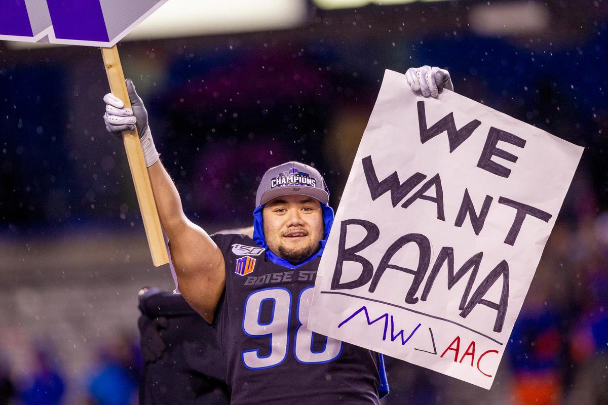 Boise State nose tackle Sonatane Lui holds a “We want Bama” sign after the Mountain West championship game against Hawaii at Albertsons Stadium. Boise State defeated Hawaii 31-10. Lui was the defensive player of the game.