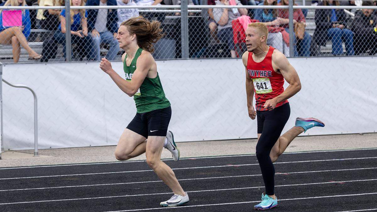 Eagle's Trev Larson and Owyhee's Noah Fisher compete in the 6A boys 300 meter hurdles at the IHSAA 6A/5A Track and Field Championships, Saturday, May 16, 2026 at Mountain View High School.