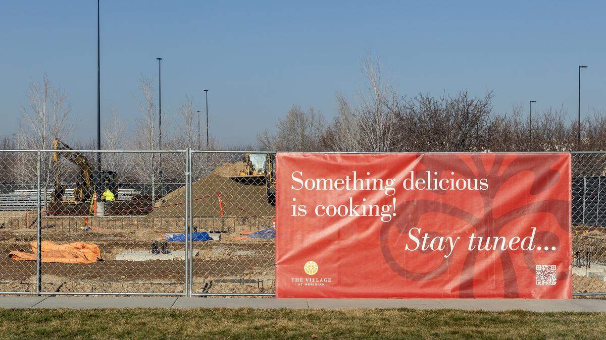A lot on the west side of The Village is fenced off as construction begins. The Village is expanding and adding seven new buildings.