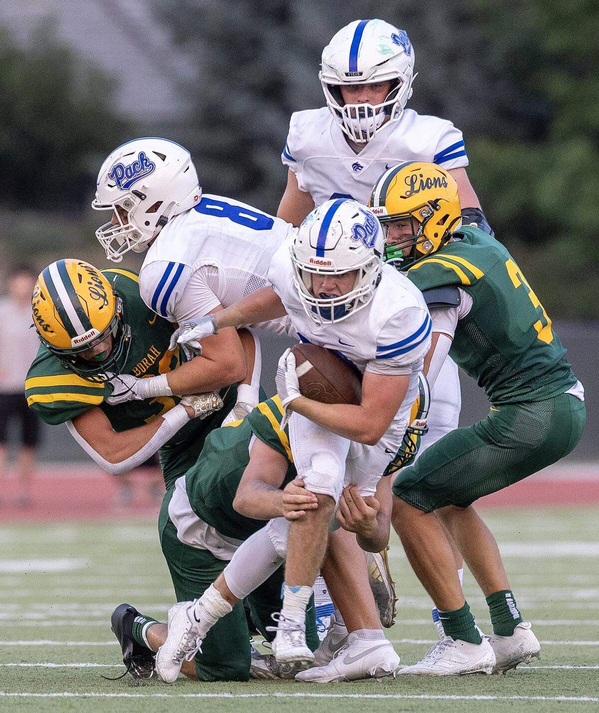 Timberline junior running back Kole Hudson is stopped by Borah defenders in the second quarter of their football game at Dona Larsen Park, Friday, August 29, 2025.