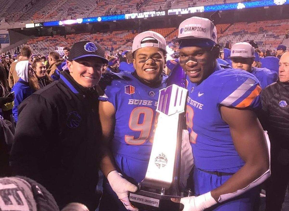 Spencer Danielson, left, poses with Curtis Weaver and Jabril Frazier after winning the 2017 Mountain West championship game. Danielson was a graduate assistant and defensive ends coach during Frazier’s  playing days at Boise State.