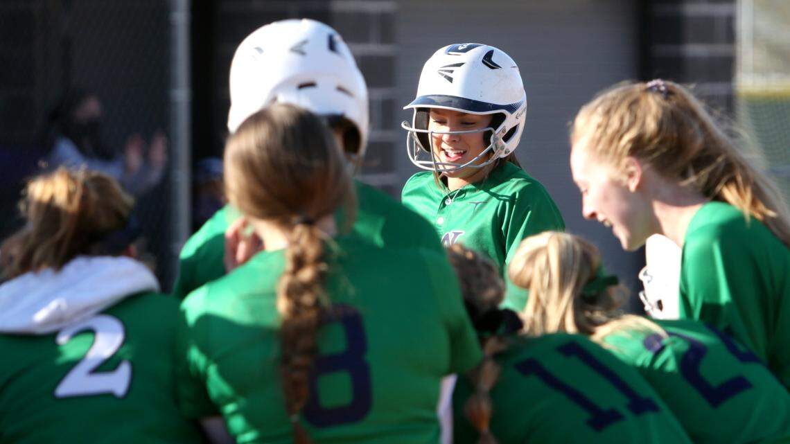 Teammates swarm Mountain View senior Riley McGrath, facing, after her three-run home run Tuesday at Rocky Mountain High.