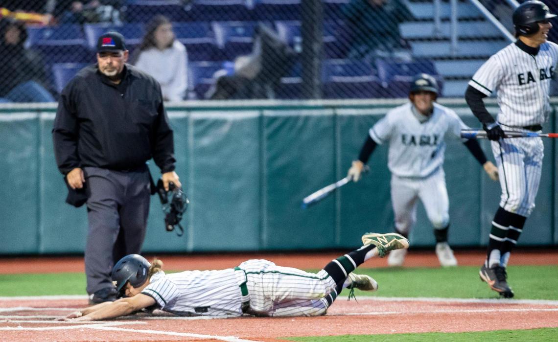 Eagle senior Ethan Wolff slides into home plate on a wild pitch, scoring the game-winning run to defeat Rocky Mountain in the semifinals of the 5A baseball state tournament Friday at Wolfe Field in Caldwell.