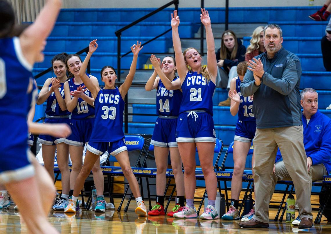 Cole Valley Christian’s bench cheers after a 3-pointer against Melba in the 2A District Three girls basketball championship last week.