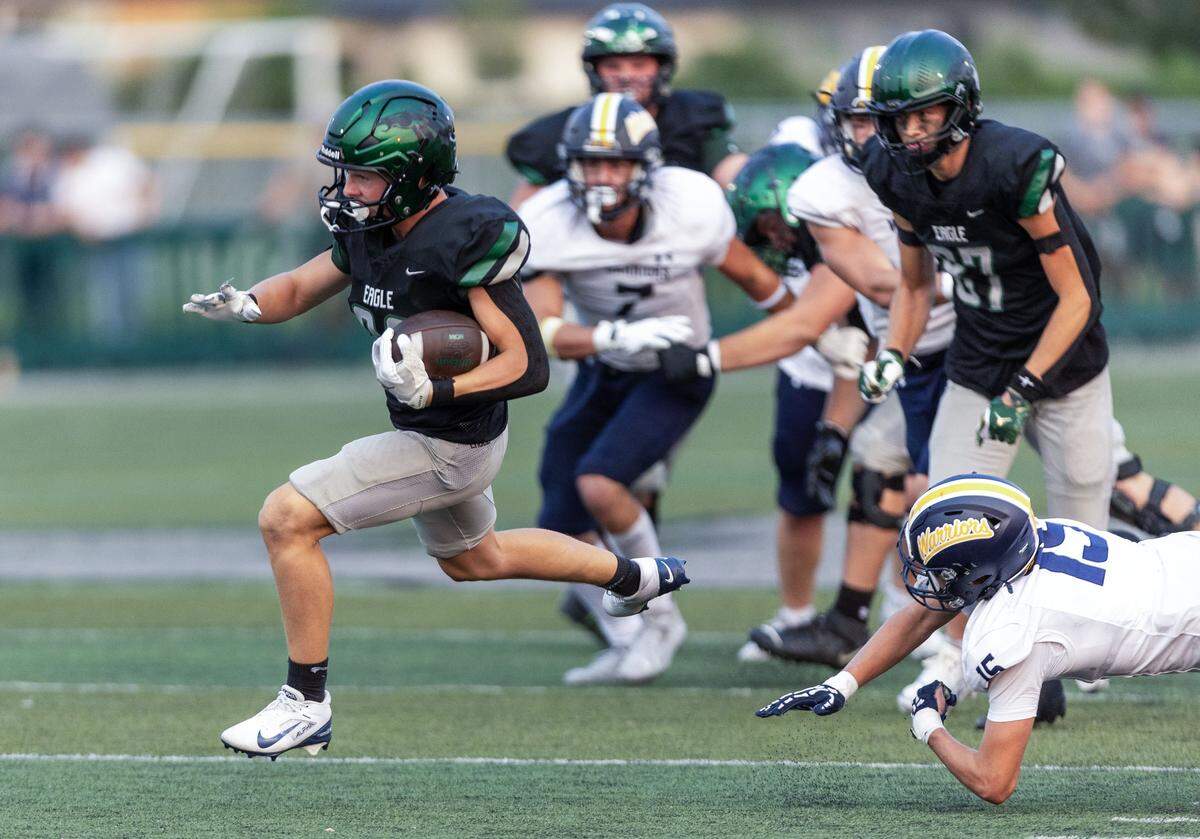 Eagle running back Bowen Blackburn breaks through Meridian's defense for a first down in the first half at Eagle, Friday, Aug. 29, 2025.