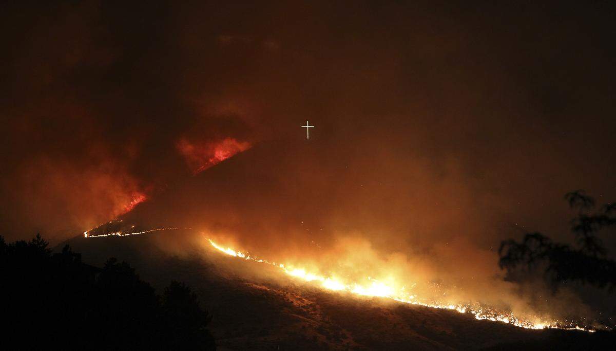 A wildfire burns near Boise's Table Rock cross in the early hours of June 30, 2016.