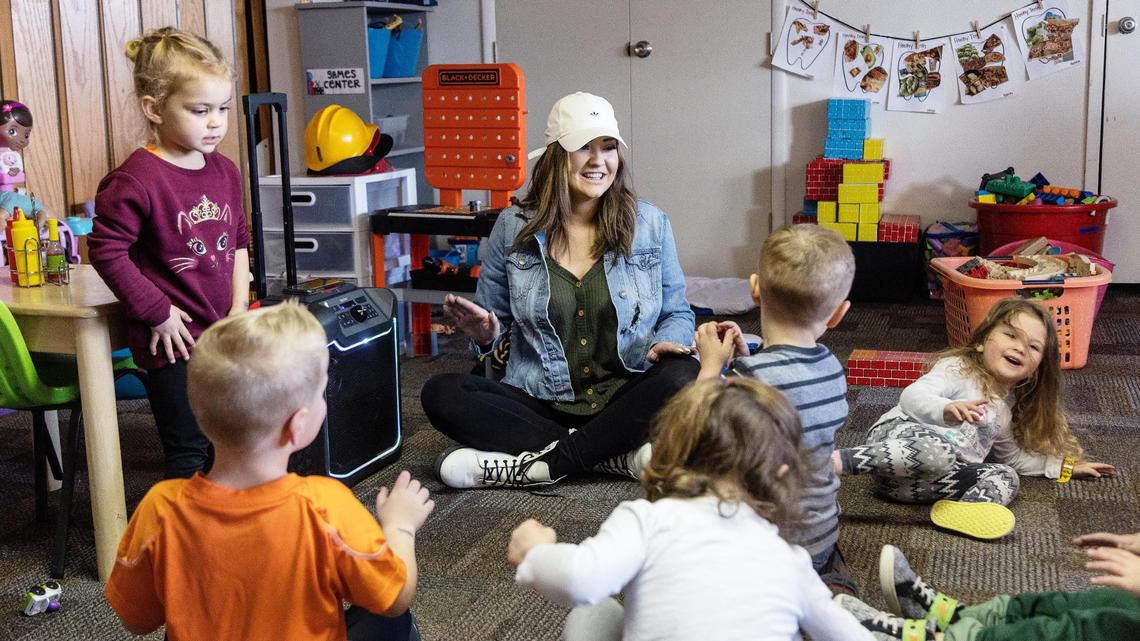 Teacher Baylee Johnson sings with the children at Ten Mile Church Daycare in Meridian. Johnson is one of eight teachers at the day care center, which is struggling to hire more people.