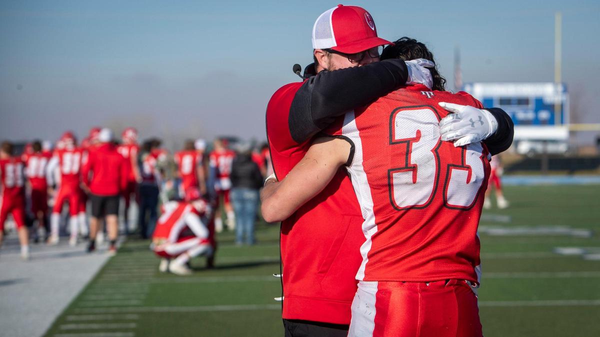 Homedale’s Keagen Christensen is consoled after he couldn’t hang on to a pass in the end zone that would have tied the score in overtime, but instead clinched Sugar-Salem’s 34-28 win in the 3A football state championship Saturday at Middleton High.