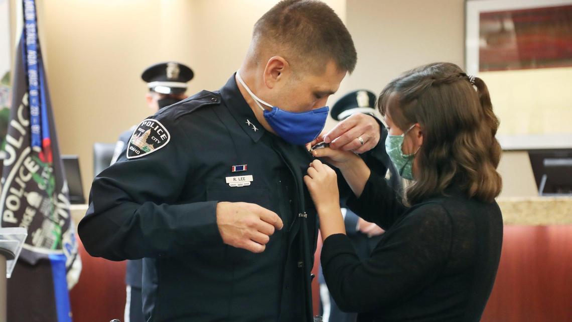 Piper Lee, 15, daughter of Boise’s new police chief, Ryan Lee, helps her father finish pinning on his new badge. Lee’s wife, Jessica, officially pinned it on her husband after he was sworn in in a ceremony at City Hall on Wednesday, July 1.