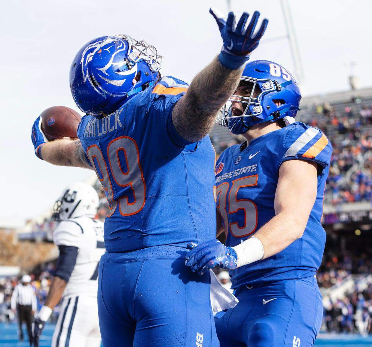 Former Boise State defensive tackle Scott Matlock celebrates his touchdown with teammate Matt Lauter in the third quarter of their football game against Utah State in 2022.