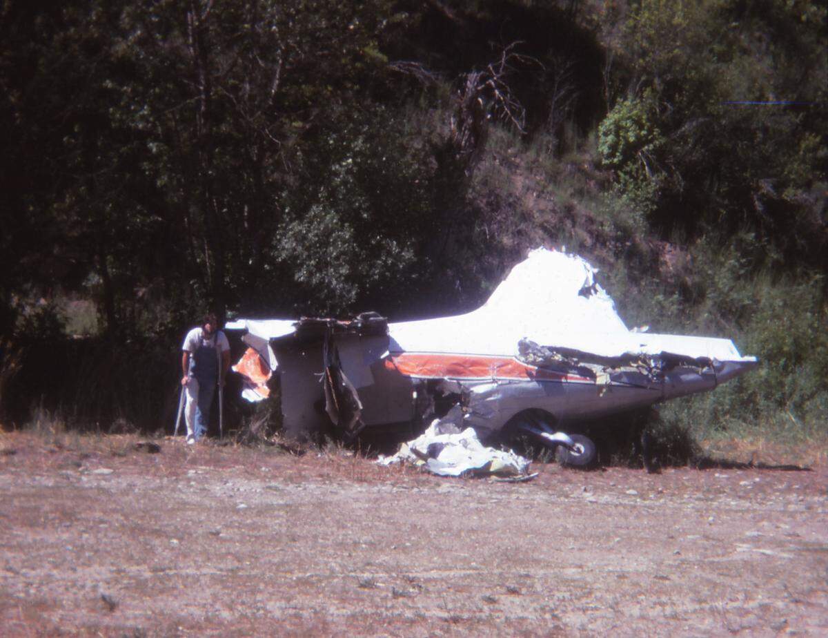 Charlie Dietz and the 148Z fuselage at the end of the Selway River Road in summer 1979. Dietz was one of two survivors of the Flight 148Z plane crash in June 1979.