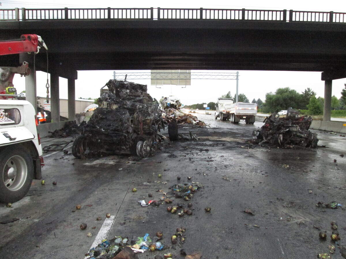 Crews clean the roadway of debris Sunday morning after a crash Saturday night where four people were killed. Seven vehicles were involved, including two semi trucks. One was carrying apples, the other pears, said the Idaho State Police.