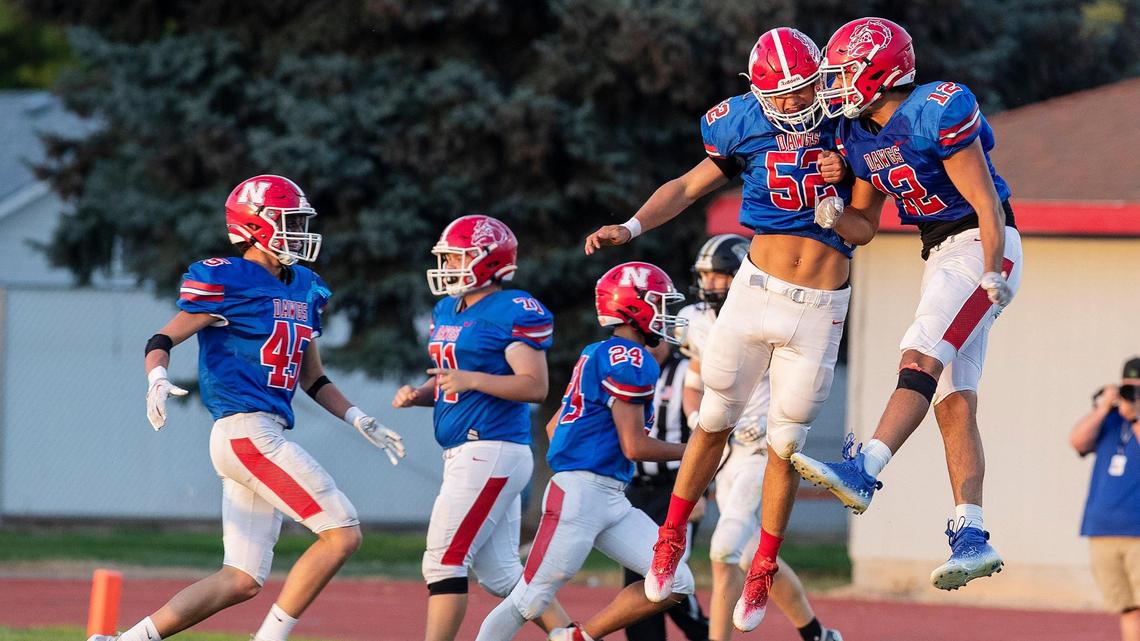 Nampa linebacker Ethan Kincheloe (52), left, celebrates with defensive end Payton Gunter, right, after Kincheloe returned a fumble for a touchdown.
