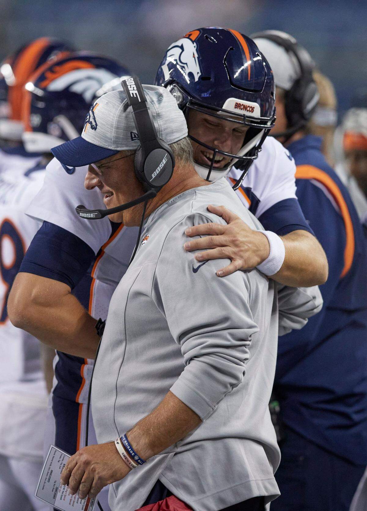 Denver Broncos quarterback Brett Rypien hugs head coach Vic Fangio after throwing a touchdown pass against the Seattle Seahawks during the second half of an NFL football preseason game on Saturday, Aug. 21, 2021, in Seattle. The Broncos won 30-3.