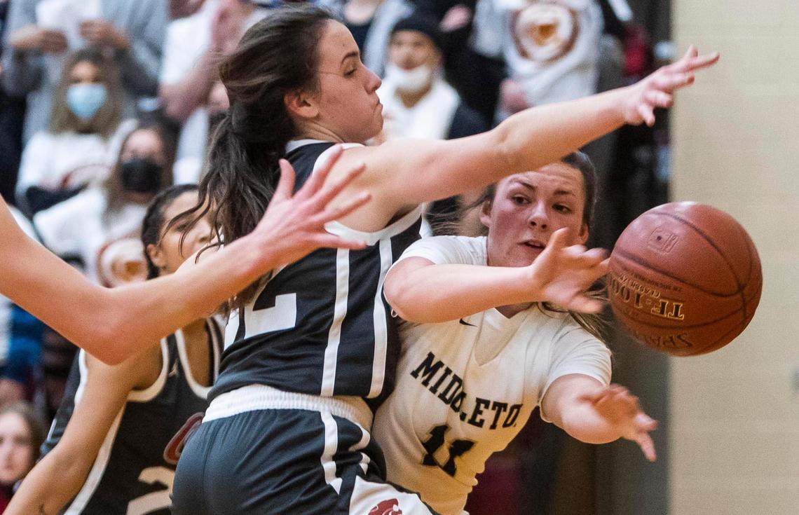 Middleton guard Reesa Whitworth makes a baseline pass defended by Columbia’s Raquel Reyna in the 4A District Three girls basketball championship Feb. 11 at Columbia High.