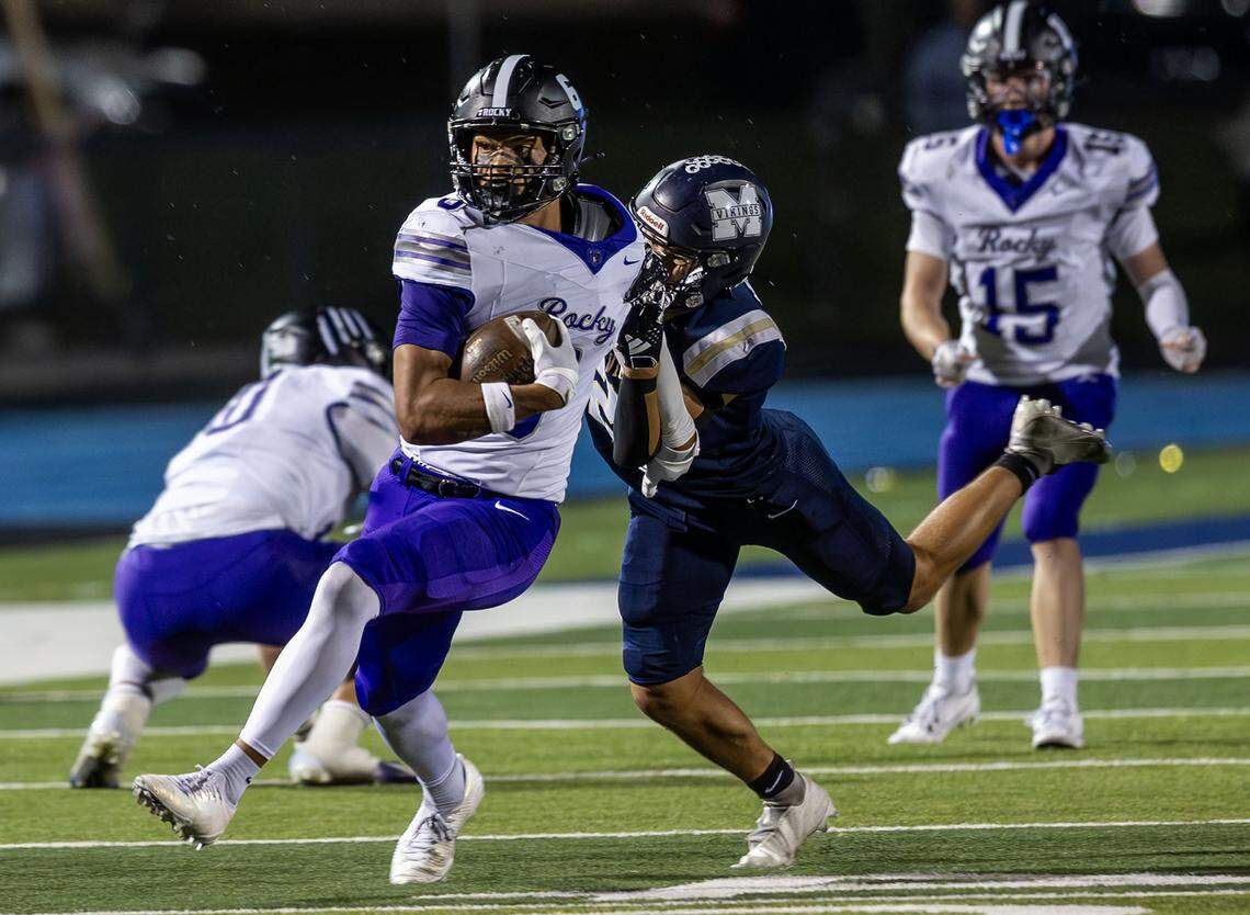 Rocky Mountain wide receiver Rasean Jones throws off Middleton's Carsen McConkie to gain extra yards at Middleton, Friday, Oct. 10, 2025.