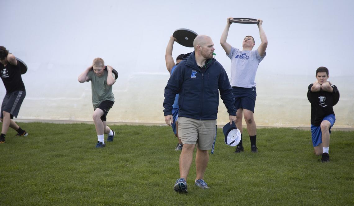 After a bout with tongue cancer, Emmett football coach Rich Hargitt has returned to the weight room and the team. During the football team’s weight workout class, he leads students in lunges and endurance drills outside.