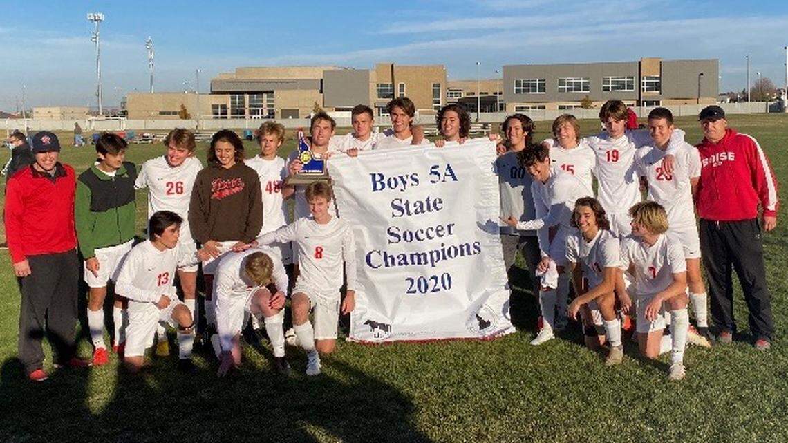 The Boise High boys soccer team poses with the 5A state championship banner after beating Thunder Ridge for the title Tuesday at Canyon Ridge High in Twin Falls.