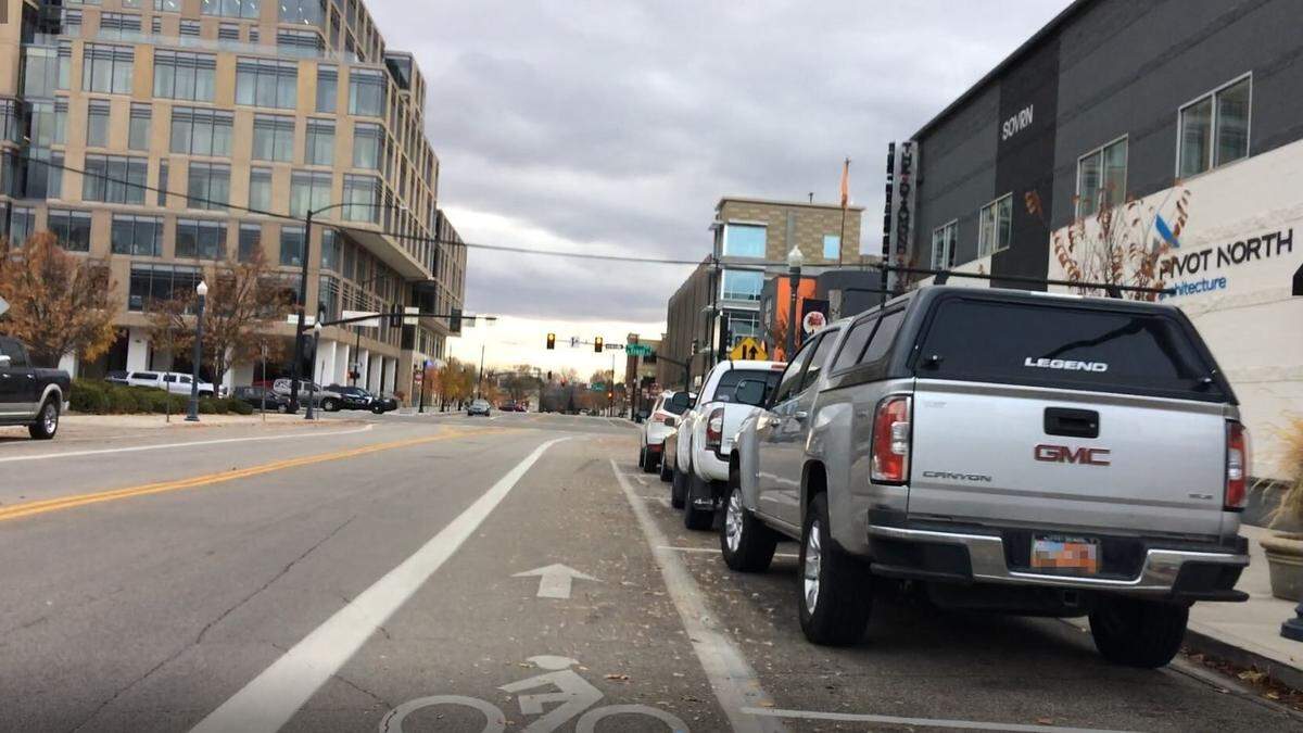 Cars and trucks park on 11th Street in downtown Boise.