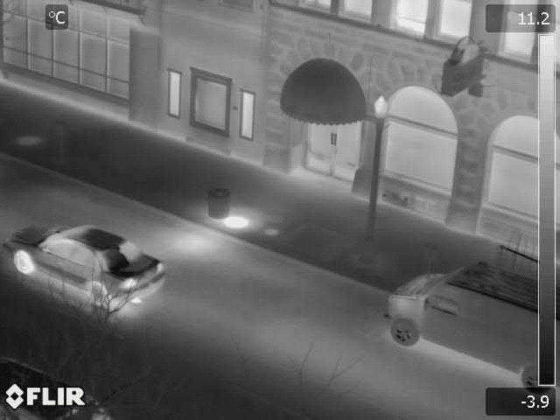 This infrared photo was taken from an airplane monitoring Downtown Boise’s geothermal system The light gray bands on the street indicate heat from underground pipes carrying hot water. The bright round spot on the sidewalk is a manhole above a major connection of the geothermal system’s components. The city reviews photos like these to check for leaks and corroding parts in the system.