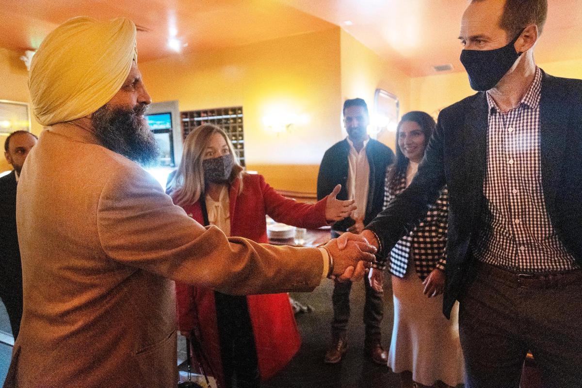 Mehar Singh, owner of Boise restaurant Bombay Grill, shakes hands with Scott McLean, husband of Mayor Lauren McLean. Bombay Grill hosted a special dinner event for Sikh Awareness and Appreciation Month.
