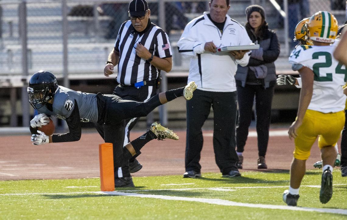 Capital’s Justus Del Rio dives across the goal line last fall against Borah.
