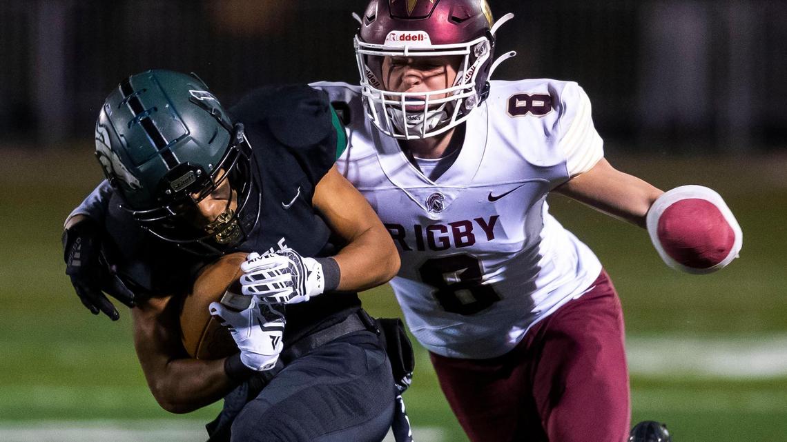 Eagle wide receiver Ian Duarte catches a first down pass defended by Rigby’s Zach Hawkes in the 5A state football quarterfinals Friday at Eagle High School.