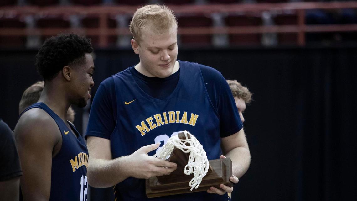 Meridian’s Brody Rowbury, right, admires the Warriors’ first state championship since 1992 in March.