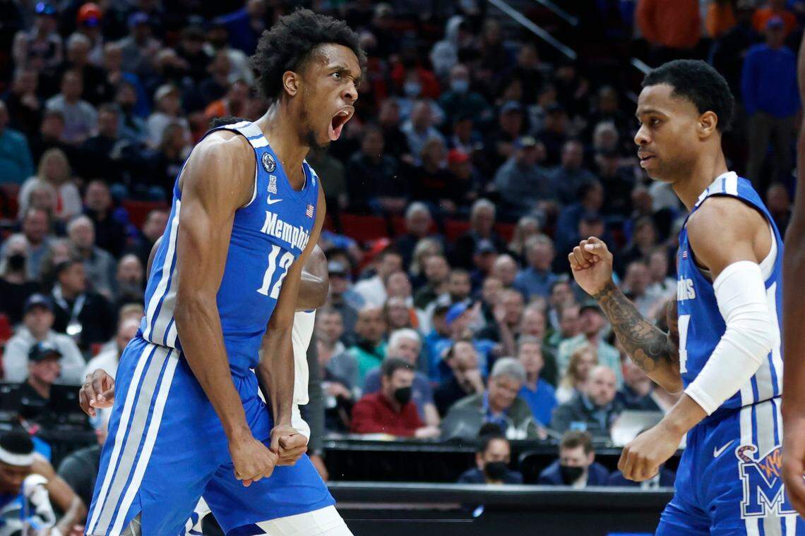 Memphis forward DeAndre Williams, left, reacts after a shot against Boise State during the second half against Boise State. The Tigers won 64-53.