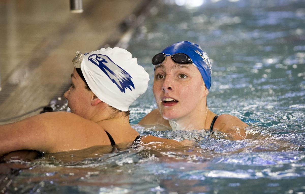 Timberline’s Eva Suggs, right, checks out the times after winning the 100-yard freestyle at the 5A state swimming championships at the West Boise YMCA.