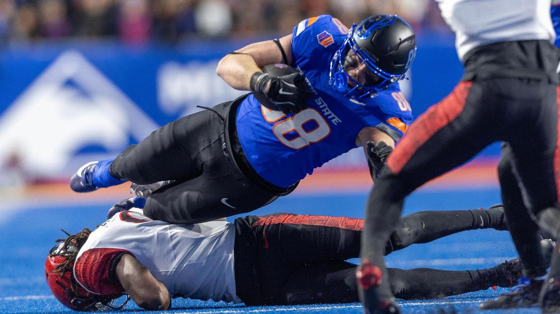 Boise State tight end Matt Wagner dives for extra yards after a catch defended by San Diego State safety Dalesean Staley at Albertsons Stadium, Friday, Nov. 1, 2024.